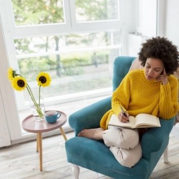 Woman journalling in chair